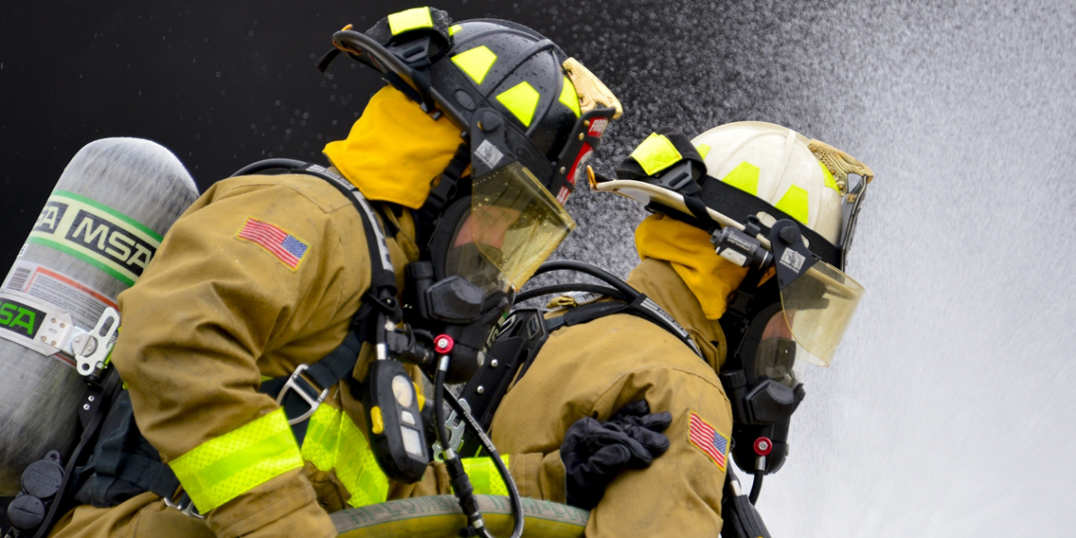 Two firefighters working to put out a fire