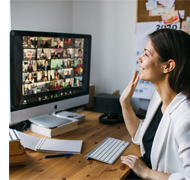 Person raising hand at home with class on virtual screen