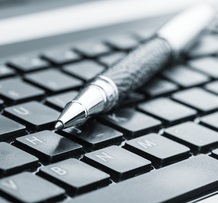 computer keyboard and pen on top