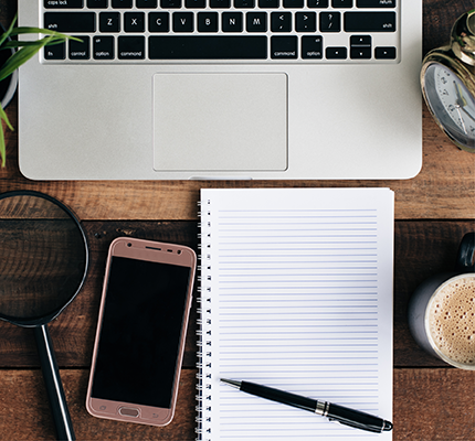 Computer, phone, writing paper and pen