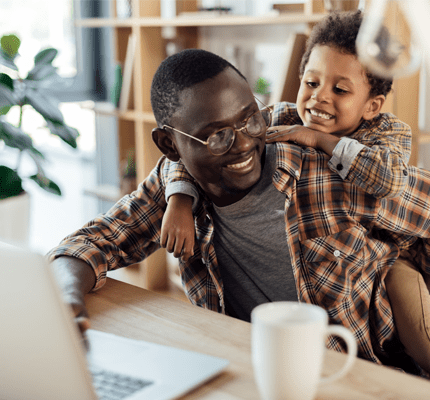 father spending time with son and working with laptop